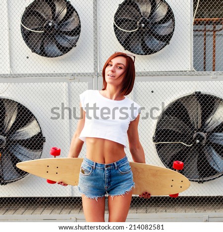 Fashion lifestyle, Beautiful young woman with skateboard, urban style big electric cooling fans