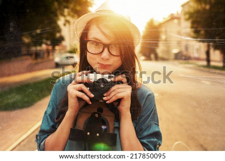 Young pretty smiling brunette woman outdoor summer closeup portrait portrait Sensual girl in white hat posing on the street in evening vintage style photo of photographer wit camera taking pictures