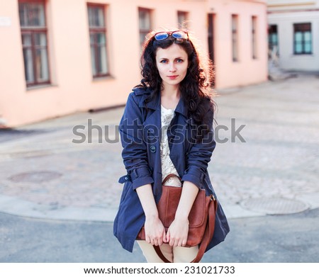 Outdoor spring european fashion woman posing outdoor in the city in evening and have fun