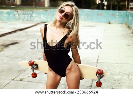 Outdoor summer fashion stunning portrait on pretty young blonde sexy woman in black bikini in summer