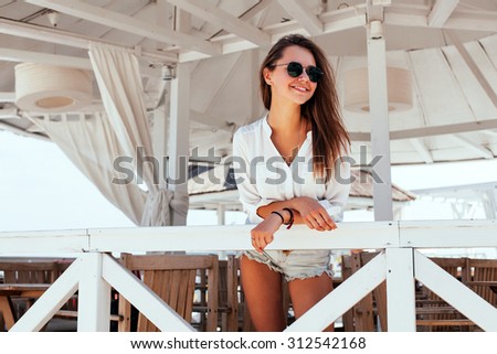Outdoor summer fashion portrait of young pretty brunette girl sensual style tanned skin happy smile