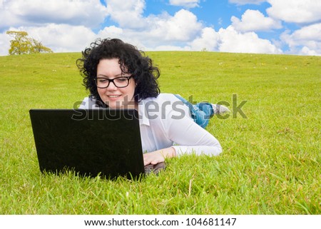 Business Woman with notebook in a meadow