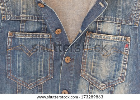 DUBLIN, IRELAND - 26 JANUARY, 2014: Close up of a Replay denim jacket with copper buttons