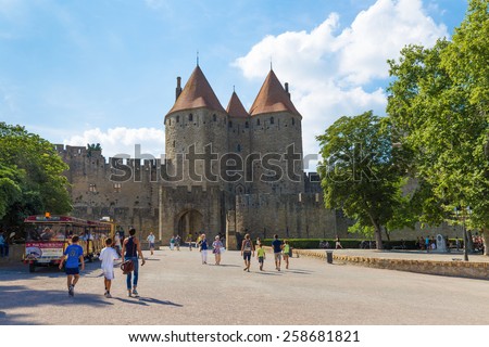 CARCASSONNE, FRANCE JULY 26, 2014: Tourists visiting the medieval fortress Cite de Carcassonne. The fortress is located in the French city of Carcassonne in the department of Aude.