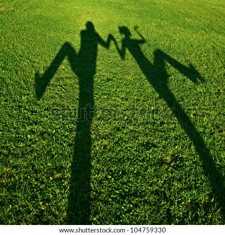 silhouettes of two persons standing with their hands stretched up