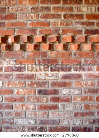 brick wall with an accent pattern in the top