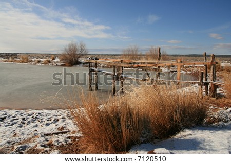 winter landscape on the arizona strip in the desert southwest  - a water reservoir for watering cattle