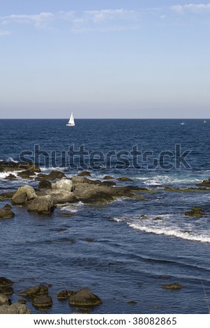 Black Sea coast and a beautiful yacht with white sails