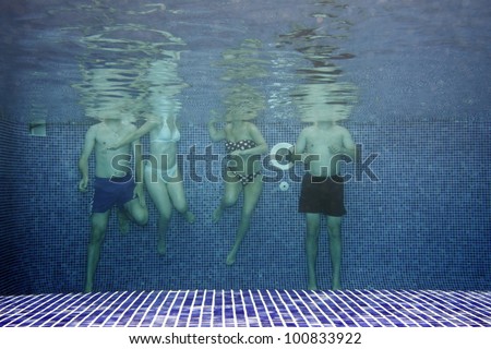 Underwater picture of people having fun in the swimming-pool