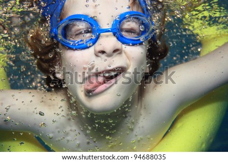 Similar – Image, Stock Photo Funny boy swimming underwater looking at camera
