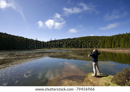 A woman feeling the pleasant moment at Canarios Lake (Lagoa do Canario), Sao Miguel Island, Azores, Portugal