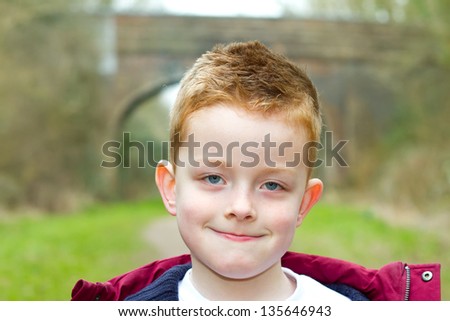 happy little boy smiling on a country trail