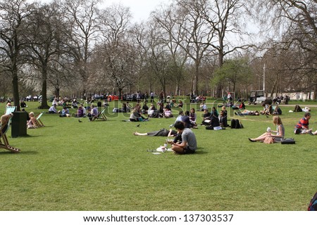 LONDON -APRIL 24: Tourists visit St James Park on 24th April 2013. This was one of the warmest days of the year so far in England\'s capital city