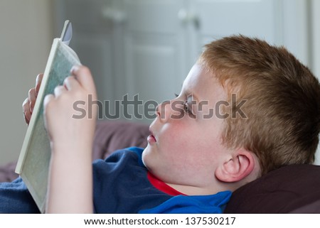 little boy reading a bedtime story in a book