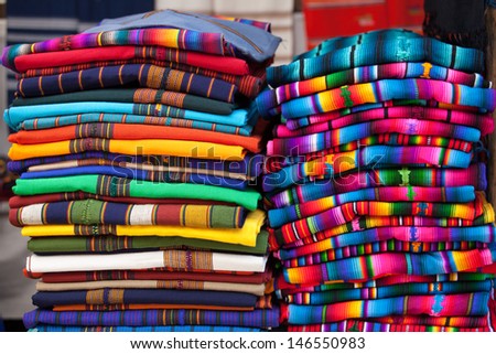 Colorful Mexican blankets for sale at market. Latin America travel background.