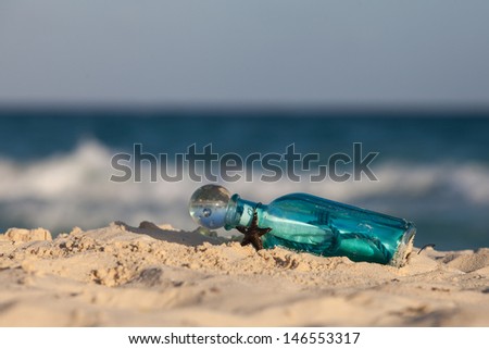 Message in the bottle on the shore of the Caribbean sea. Summer beach background.