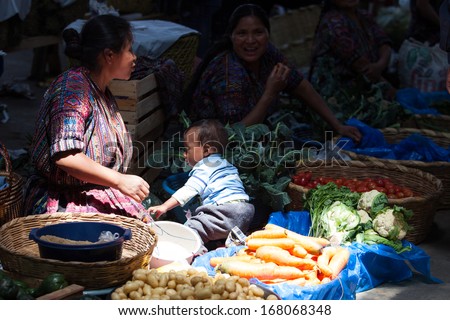 CHICHICASTENANGO, GUATEMALA- MAY 9: An unidentified woman sells vegetables at traditional weekly market in Chichicastenango (Chichi), Guatemala on 9 May 2013.