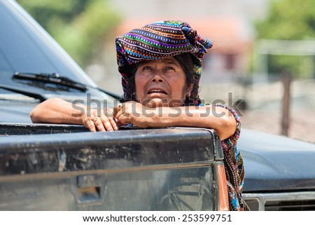 SOLOLA, GUATEMALA- MAY 10: An unidentified woman by a car truck at traditional weekly market in Solola, Guatemala on 10 May 2013.