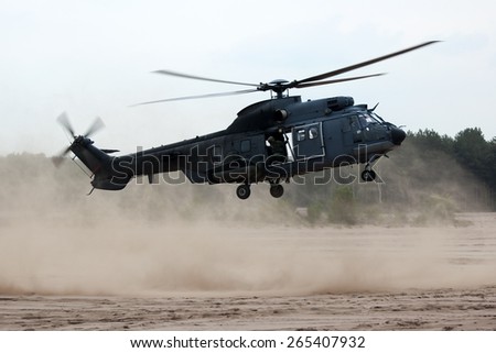 EINDHOVEN, THE NETHERLANDS--11 JULY 2014-- Royal Dutch Air Force Cougar helicopter is ready to land on the sand.