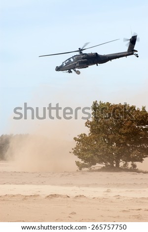 EINDHOVEN, THE NETHERLANDS--11 JUNE 2014-- A Apache helicopter from the Royal Dutch Airforce trying to land on the sand field.