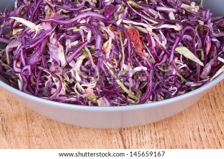 a salad of red cabbage in a bowl on the table