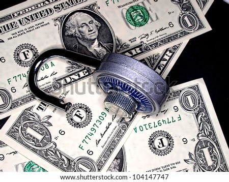 Money in the form of change or paper  bills.  Single dollar bills and combination lock..