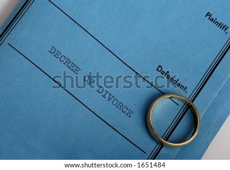 Blue divorce decree and wedding ring.