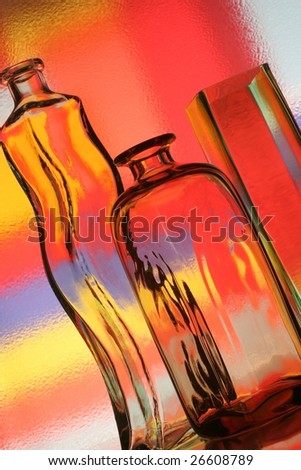 Abstract background design made from two bottles, a vase  and numerous colors.