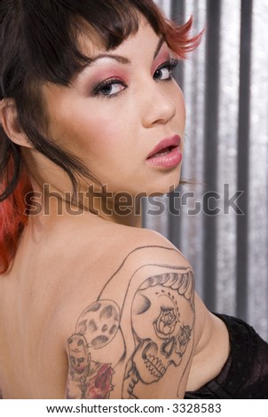 Portrait of a beautiful woman with skull tattoo.
