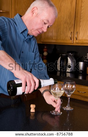 Mature man pouring wine.