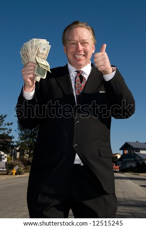 Happy man with wad of cash.