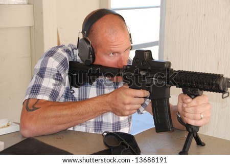 Man shooting rifle.