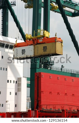 ANTWERP, BELGIUM - AUGUST 8: Loading and unloading of container-ships August 8, 2010 in Antwerp, Belgium. MSC Home terminal, one of the biggest terminals in the port