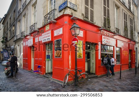 PARIS, FRANCE - OCTOBER 9, 2014: People line up at the window of a popular take-out restaurant mi-va-mi on Rue des Rosiers at the corner of Rue des Ecouffes in the Jewish neighborhood of Marais.