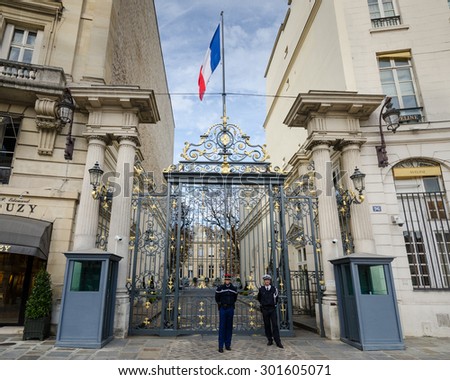 PARIS, FRANCE - OCTOBER 8, 2014: The entrance to the Ministry of the Interior in Place Beauvau is jointly guarded by one gendarme and one policewoman bridging the differences between the services.