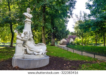 PARIS, FRANCE - AUGUST 28, 2015: Monceau Park is one of the most beautiful in the city with dozens of white marble statues of famous French celebrities including novelist and poet Guy de Maupassant.