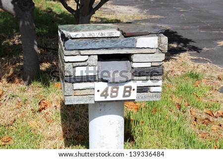 Unusual mail box constructed  and designed from flat  pieces of stone  adds class  and interest to a suburban street.