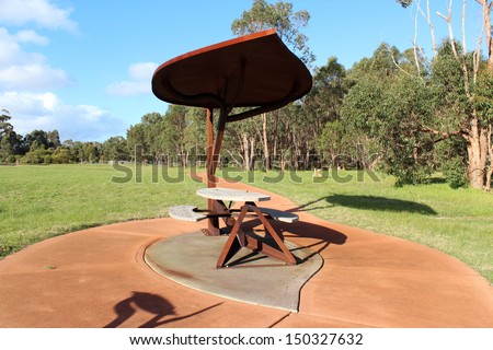 Scenic view of the  unique  metal  gum leaf shaped picnic table and seats in the Joshua Brook nature reserve  near Boyanup south western Australia on a sunny afternoon in late winter .