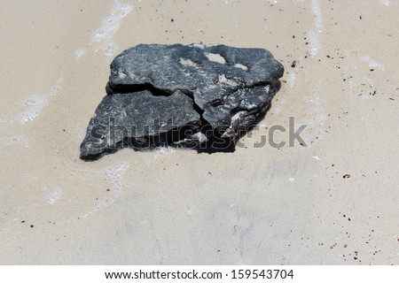 Fresh black ambergris washed up on the sandy beach at Hutt\'s Beach near BUnbury Western Australia after storm in early spring is a perfume fixative from whale intestines.