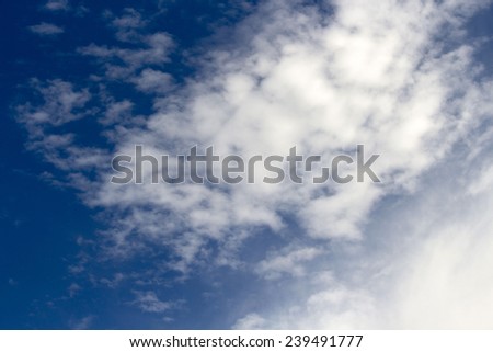 High cirrocumulus cloud formations  on  a sunny afternoon in early summer  are contrasted against the blue Australian sky.