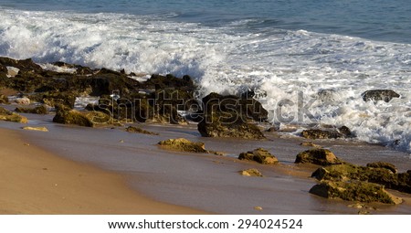 Scenic   view of the Indian Ocean at rolling in over the rocks    at Buffalo Beach near Bunbury Western Australia on a   late afternoon in  mid winter.