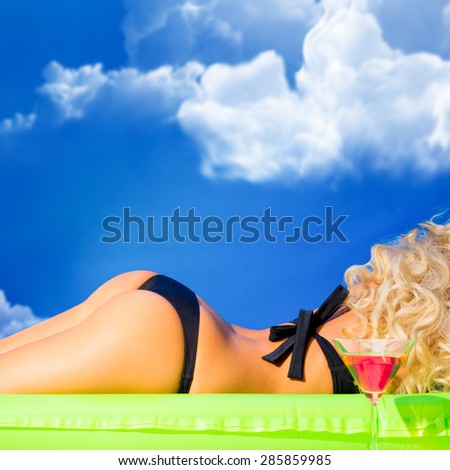 girl sunbathing on an air mattress green open air