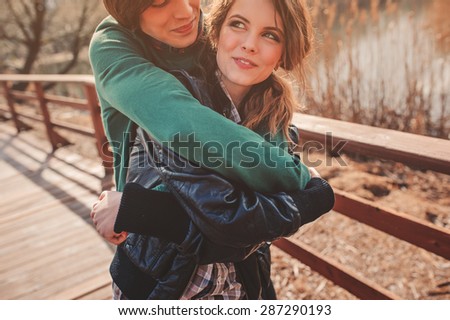 lifestyle capture of happy young loving couple hugs at outdoor walk