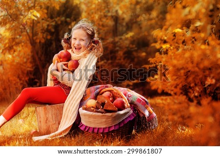 autumn portrait of happy child girl with fresh home growth apples in the garden