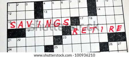 The Words Savings and Retire on Crossword Puzzle in Red Ink, Copy Space