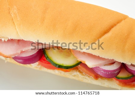 Small sandwich with deli meats and vegetables. Closeup view