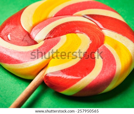 Red-Yellow Lollipop on green background