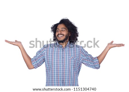 Close shot of a young man wears a shirt, holding two things and comparing between them, isolated on white background Stock foto © 