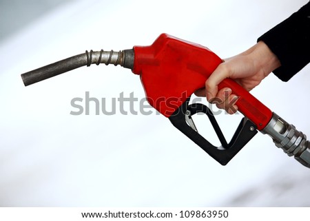 Gas nozzle in woman\'s hand