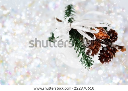 White snowy Christmas decoration with baubles, fir branch, and cones. Holiday greeting card concept.